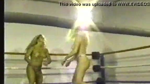 Two bikini clad bitches wrestle in ring