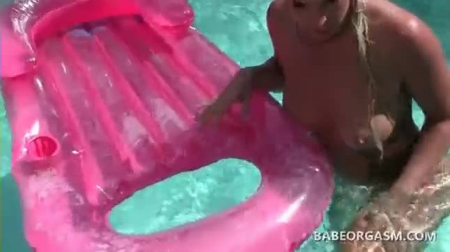 Blonde tanning in the pool fucks herself with a sex toy